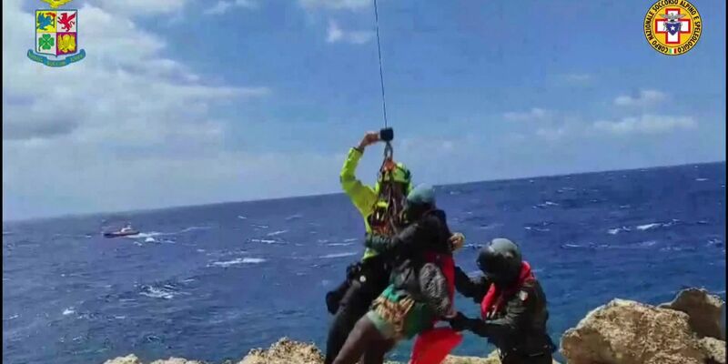 Das von der italienischen Bergwacht zur Verfügung gestellte Videostandbild zeigt eine Rettungsaktion in einer unwegsamen Bucht auf Lampedusa. - Foto: Italy Alpine Rescue/Italian Alpine Rescue/AP/dpa