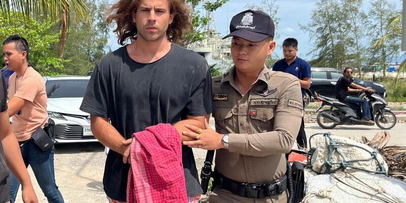 Ein thailändischer Polizist (r.) mit dem verdächtigen Spanier, der den Mord an dem Chirurgen gestanden hat. - Foto: Somkeat Ruksaman/AP/dpa