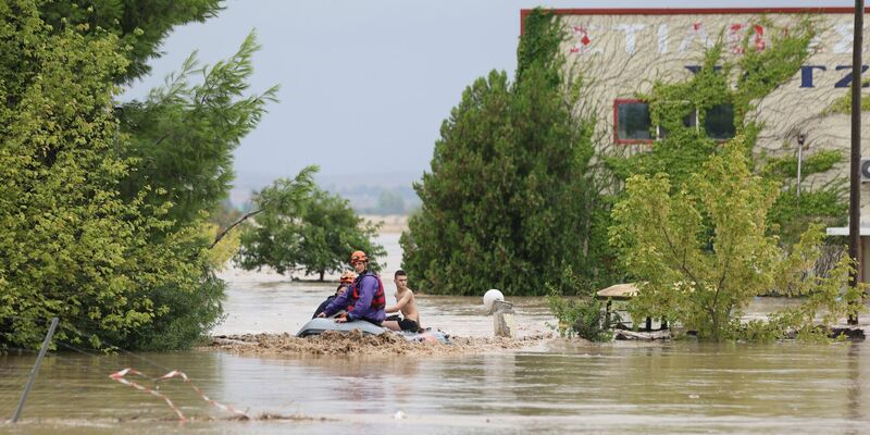 Feuerwehrleute evakuieren Menschen aus einem überfluteten Gebiet in Larisa. - Foto: Vaggelis Kousioras/AP/dpa