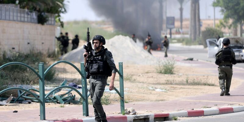 Israelische Soldaten gehen nach dem Hamas-Terrorangriff durch einen Grenzort. - Foto: Ilan Assayag/AP/dpa
