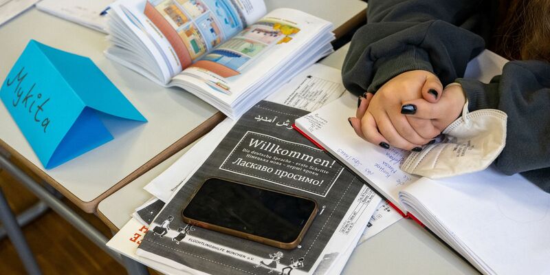 Ein Mädchen aus der Ukraine sitzt mit ihrem Unterrichtsmaterial in einer Klasse. - Foto: Peter Kneffel/dpa