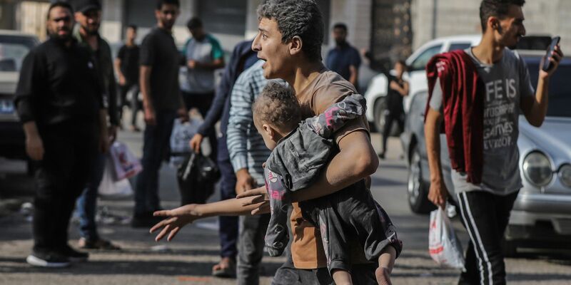 Ein Mann trägt nach einem israelischen Luftangriff auf Gaza-Stadt ein verletztes Kind auf dem Arm. - Foto: Mohammed Abu Elsebah/dpa
