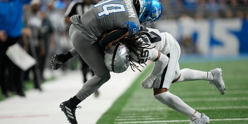 Detroit Lions Wide Receiver Amon-Ra St. Brown (14) wird von Las Vegas Raiders Safety Tre'von Moehrig (25) aus dem Spielfeld gedrängt. - Foto: Paul Sancya/AP