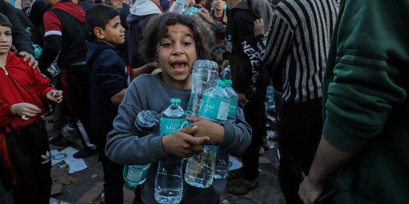 Wasserflaschen werden in Chan Junis im südlichen Gazastreifen verteilt. Der Deal mit Israel sieht der Hamas zufolge auch vor, dass 300 Lastwagen mit Hilfsgütern in den Gazastreifen einfahren. Dies könnte die Notlage in dem Küstengebiet zumindest ein bisschen verbessern. - Foto: Rizek Abdeljawad/Xinhua/dpa