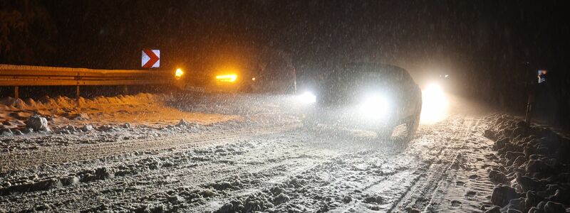 Autofahrer sind auf einer verschneiten Straße bei Niedernhausen unterwegs. - Foto: Jörg Halisch/dpa