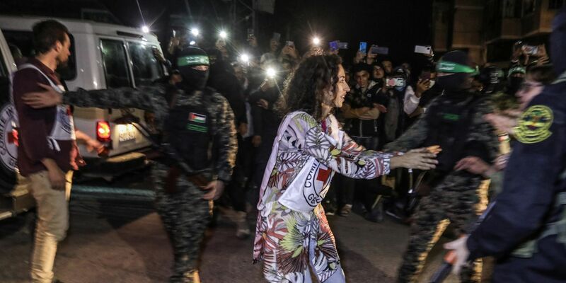 Kämpfer der Hamas und des Islamischen Dschihad übergeben dem Roten Kreuz in Rafah freigelassene Geiseln. - Foto: Stringer/dpa