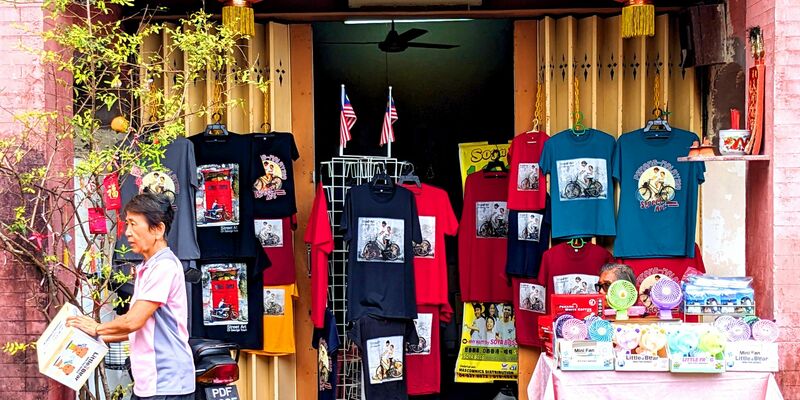 T-Shirts und andere Dinge, auf denen Street Art-Kunstwerke aus Penang abgebildet sind, werden in einem Geschäft zum Kauf angeboten. - Foto: Genevieve Tan Shu Thung/dpa