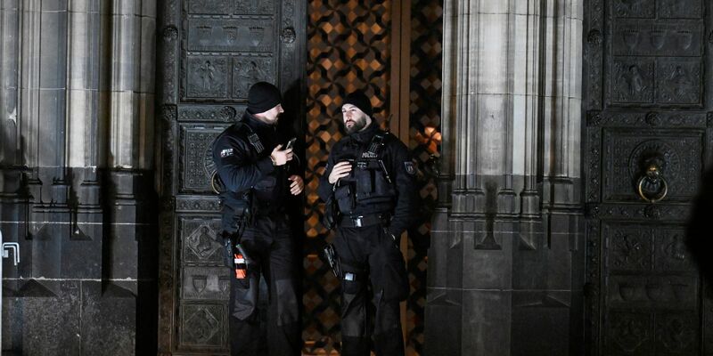 Polizisten sichern einen Eingang zum Kölner Dom. - Foto: Roberto Pfeil/dpa