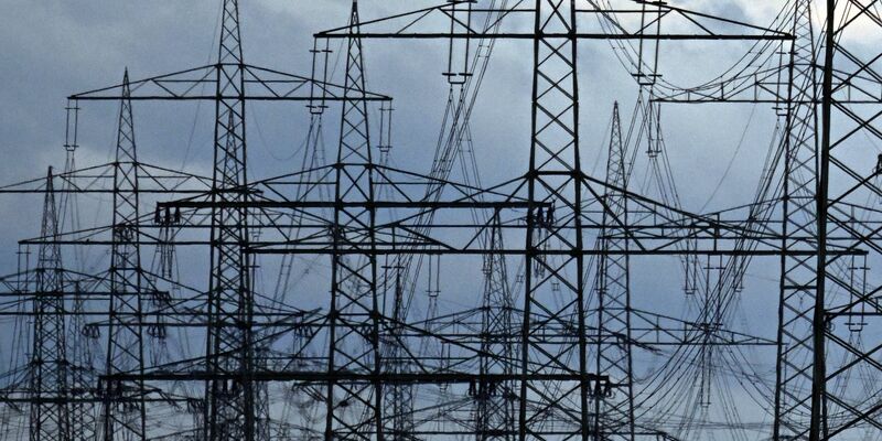 Strommasten auf einem Acker. «Die Zeit der billigen Energie ist vorbei», meint Netzagenturchef Müller. - Foto: Federico Gambarini/dpa
