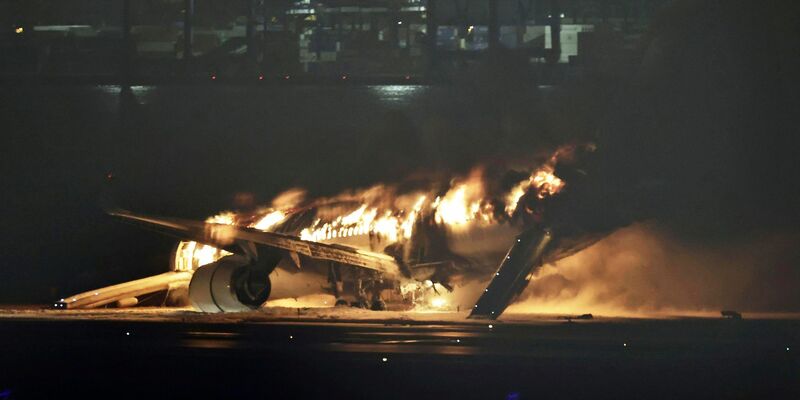 Ein Flugzeug der Japan Airlines brennt auf der Landebahn des Tokioter Flughafens Haneda. - Foto: Uncredited/Kyodo News/AP/dpa
