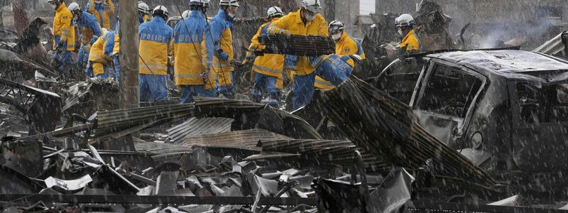 Einsatzkräfte suchen in den Trümmern auf einem Markt in der Präfektur Ishikawa. - Foto: Uncredited/Kyodo News/AP/dpa