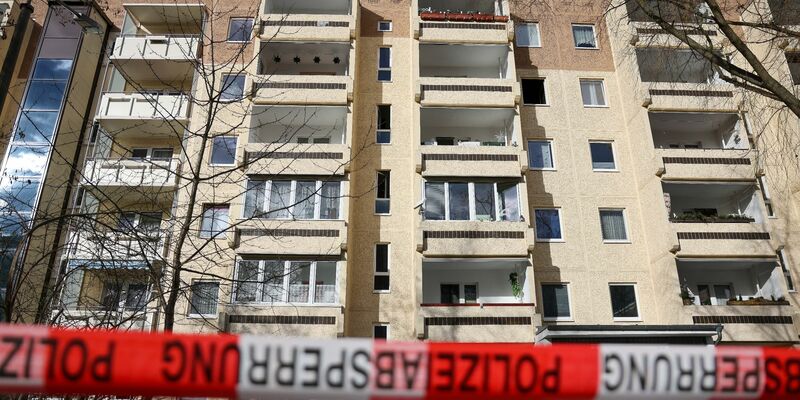 Absperrband der Polizei hängt nach dem Brand im Leipziger Stadtteil Paunsdorf vor dem Plattenbau. - Foto: Jan Woitas/dpa