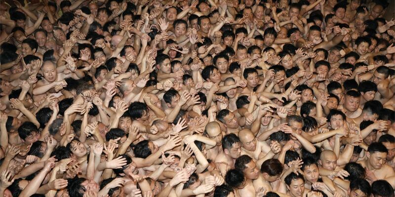 Männer, die nur mit einem Lendenschurz bekleidet sind, drängeln sich bei dem über 500 Jahre alten Saidaiji-Eyo-Festival im Saidaiji-Tempel, um einen heiligen Holzstab zu ergattern. - Foto: -/kyodo/dpa