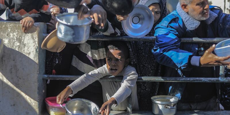Palästinenser an einer von einer Wohltätigkeitsorganisation eingerichteten Lebensmittel-Spendenstelle. - Foto: Mohammed Talatene/dpa