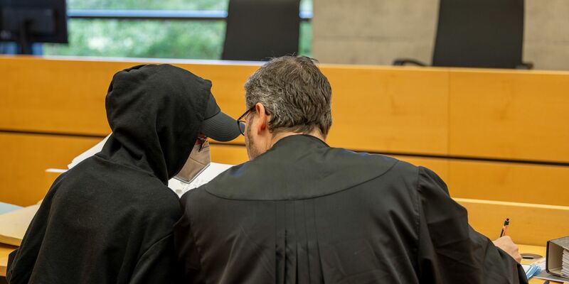 Eine der beiden Angeklagten (l) unterhält sich mit ihrem Rechtsanwalt im Sitzungssaal im Landgericht. - Foto: Heiko Becker/dpa