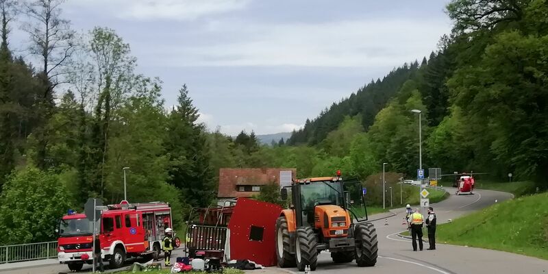 Unfall mit Maiwagen: Rettungskräfte neben dem umgestürzten Maiwagen in Kandern. - Foto: Gudrun Gehr/Oberbadisches Verlagshaus/dpa