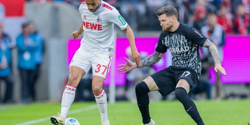 Kölns Linton Maina (l) im Zweikampf mit dem Freiburger Lukas Kübler. - Foto: Rolf Vennenbernd/dpa
