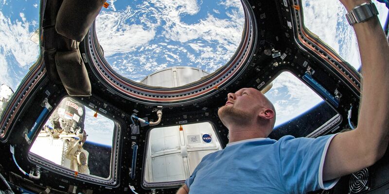 Alexander Gerst blickt während seines Fluges mit der Internationalen Raumstation ISS durch ein Fenster in der Kuppel auf die Erde. - Foto: Nasa/dpa
