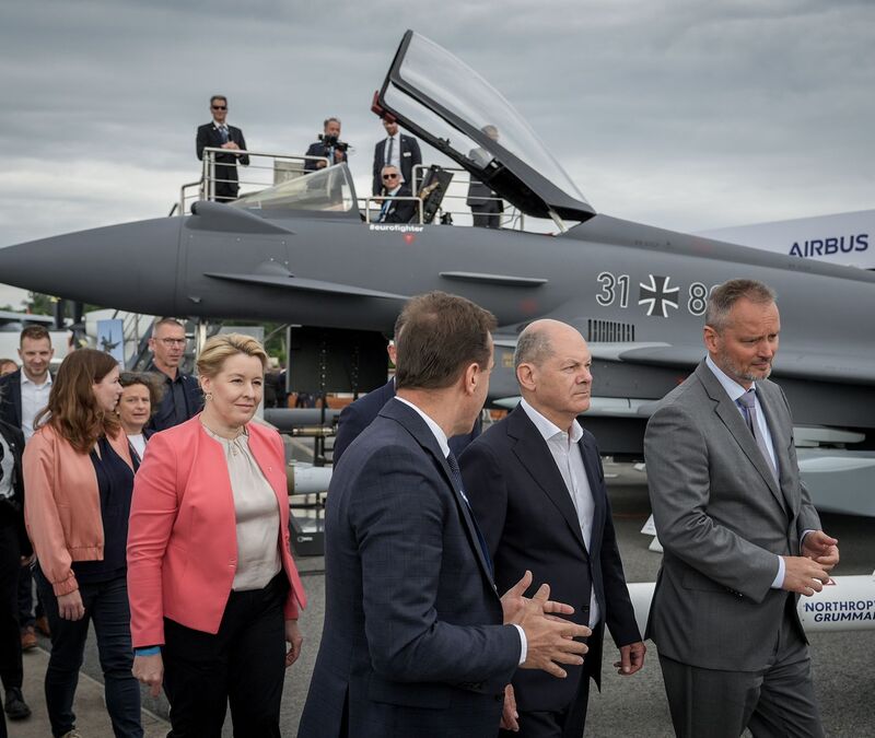Bundeskanzler Olaf Scholz (SPD,2.v.r) auf der Internationalen Luft- und Raumfahrtausstellung (ILA) vor einem mit einem Taurus-Marschflugkörper bestückten Eurofighter. - Foto: Kay Nietfeld/dpa
