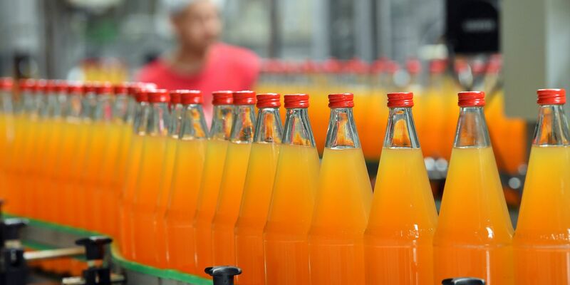 Apfelsaft wird abgefüllt. Zahlen des Statistischen Bundesamt zeigen: Orangensaft und ähnliche Säfte waren 2023 gut 30 Prozent teurer als im Jahr 2020. - Foto: Martin Schutt/dpa-Zentralbild/dpa