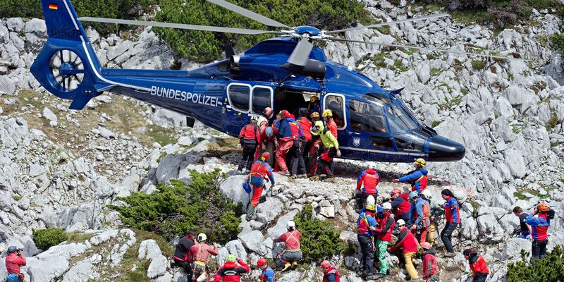 Rettungskräfte tragen am 19.06.2014 am Untersberg bei Marktschellenberg (Bayern) nahe des Einstiegs der Riesending-Schachthöhle den verletzten Höhlenforscher Johann Westhauser auf einer Trage in einen Helikopter der Bundespolizei. - Foto: Nicolas Armer/dpa