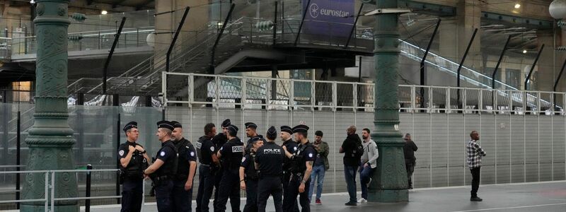 Reisende sitzen wegen der Brandanschläge an einem Bahnhof in Paris fest. - Foto: Mark Baker/AP