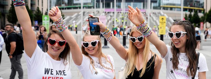 Swifties freuen sich vor dem Wembley-Stadion auf das  Eras-Tour von Taylor Swift . - Foto: Alastair Grant/AP/dpa