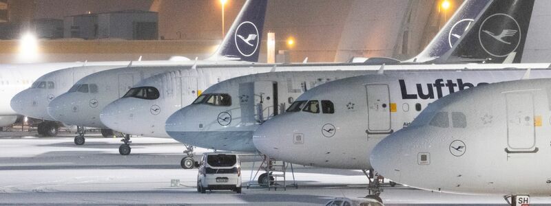 Mit Schnee bedeckte Flugzeuge auf dem Flughafen Frankfurt. Wegen Schnee und Eisregen sind hier 120 Flüge annulliert worden. - Foto: Lando Hass/dpa