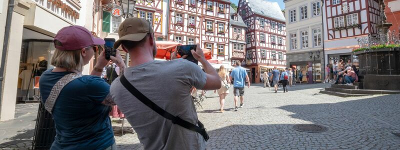 Touristen im Fachwerk-Städtchen Bernkastel-Kues. Die Lust aufs Reisen ist ungebrochen. (Archivbild) - Foto: Harald Tittel/dpa