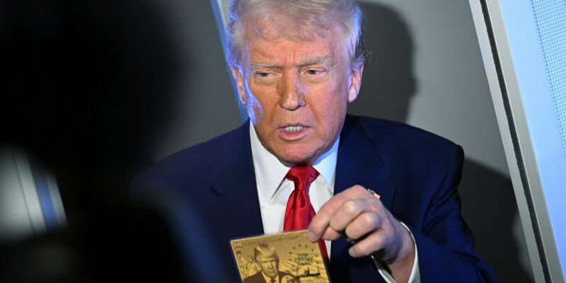 US-Präsident Donald Trump zeigt eine sogenannte Gold Card, auf der er abgebildet ist.  - Foto: Uncredited/AP/dpa