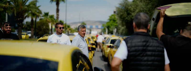 Mit ihrem Protest-Konvoi legen die Taxifahrer wichtige Verkehrsadern lahm. - Foto: Petros Giannakouris/AP/dpa