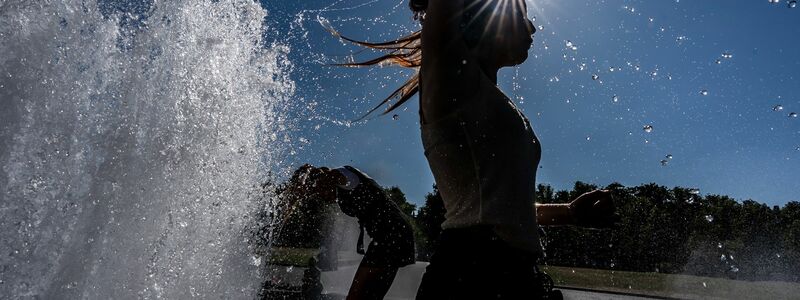 Temperaturen von annähernd 40 Grad in der Hauptstadt - diese Touristen nutzen einen Brunnen zur Abkühlung. - Foto: Michael Kappeler/dpa