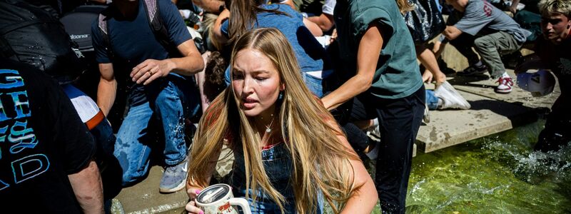 Menschen rennen weg, nachdem Kirk angeschossen wurde. - Foto: Tess Crowley/The Deseret News/dpa