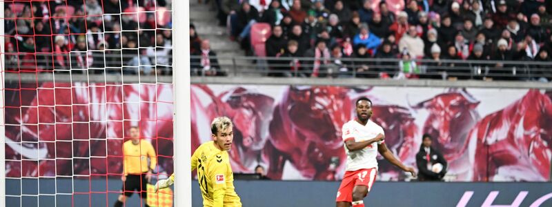 Bremens Torwart Mio Backhaus (l, Werder Bremen) und Ridle Baku (RB Leipzig) schauen dem Ball hinterher. Backhaus verhinderte mit seinen Paraden einen frühen Rückstand der Gäste in Leipzig. - Foto: Jennifer Brückner/dpa