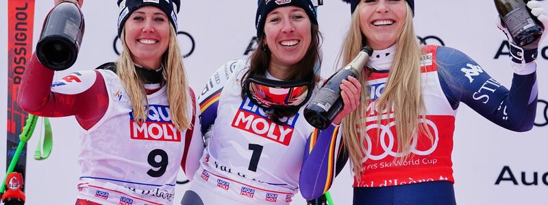 Neben Siegerin Hütter (links) und der drittplatzierten Vonn (rechts) lässt es sich gut feiern. - Foto: Pier Marco Tacca/AP/dpa