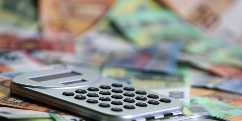 Ein Taschenrechner liegt auf verschiedenen Euro-Banknoten. (Symbolbild) - Foto: Karl-Josef Hildenbrand/dpa