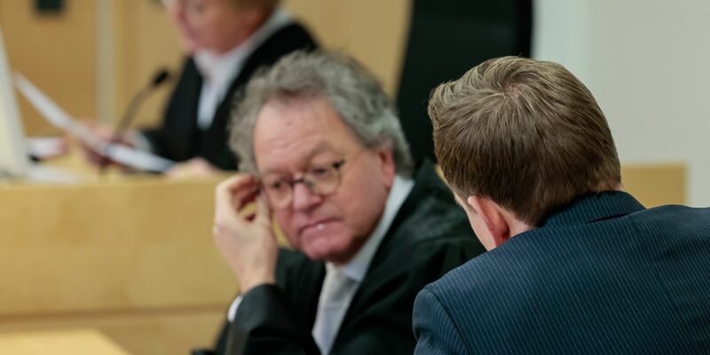 Der angeklagte Jurist (nur sein Hinterkopf ist zu sehen) sieht strafrechtlich keine Schuld bei sich. - Foto: David Ebener/dpa