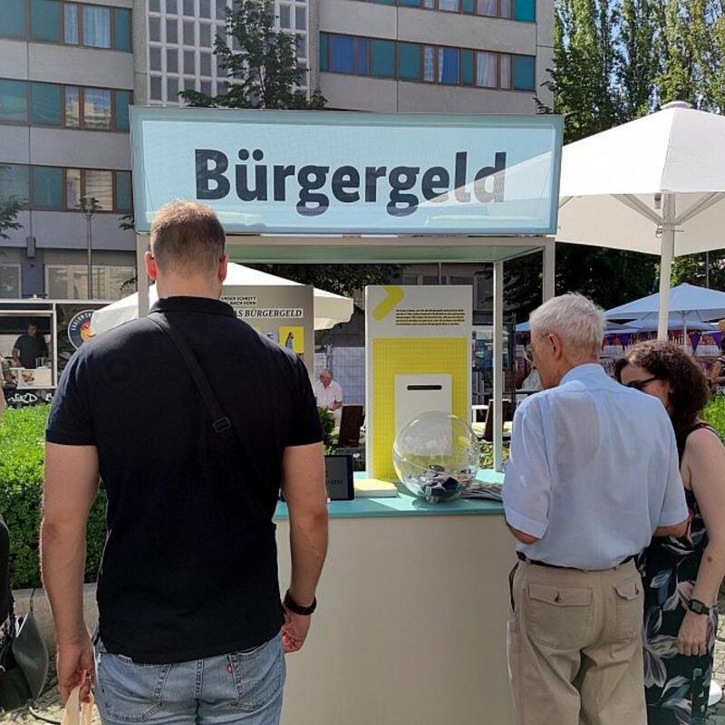 Passanten an einem Bürgergeld-Infostand (Archiv) - Foto: via dts Nachrichtenagentur