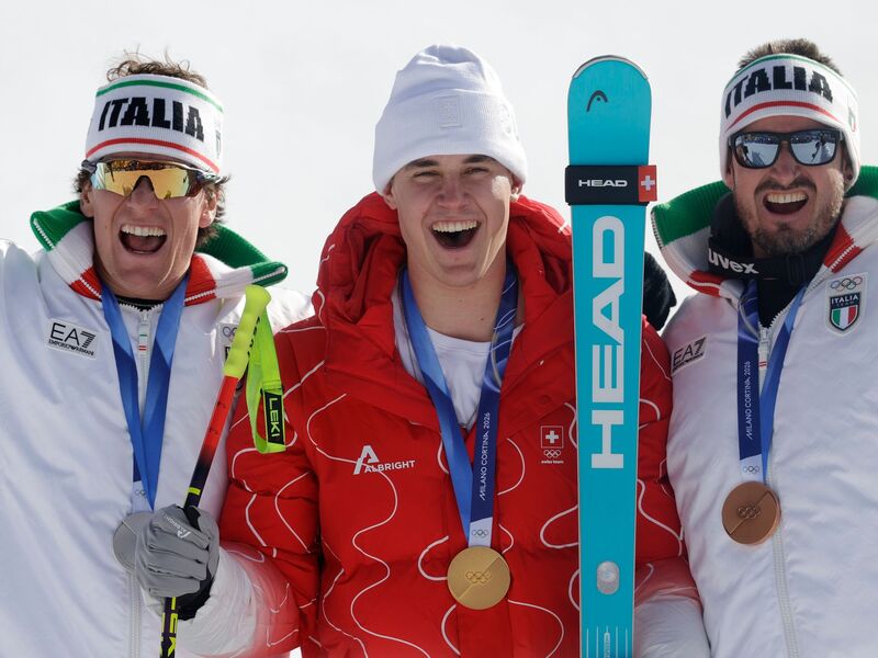Olympiasieger Franjo von Allmen wird flankiert von Silber-Gewinner Giovanni Franzoni (links) und dem Drittplatzierten Dominik Paris. - Foto: Oliver Weiken/dpa