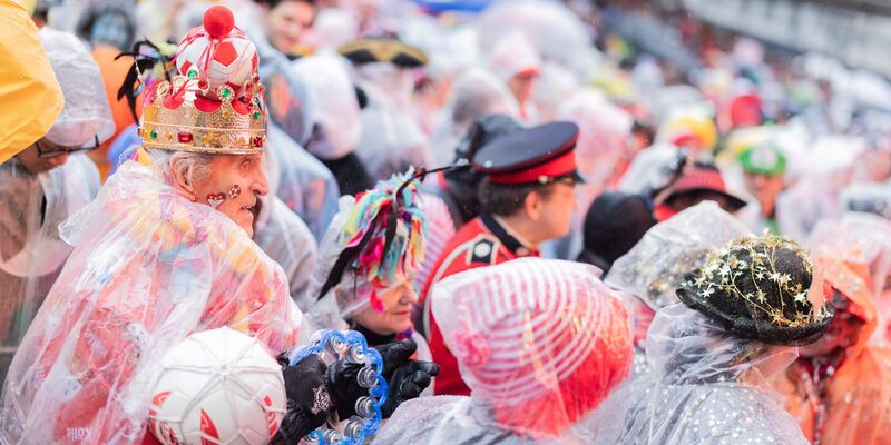Auch durch strömenden Regen lassen sich die Karnevalisten nicht vom Feiern abhalten. - Foto: Rolf Vennenbernd/dpa