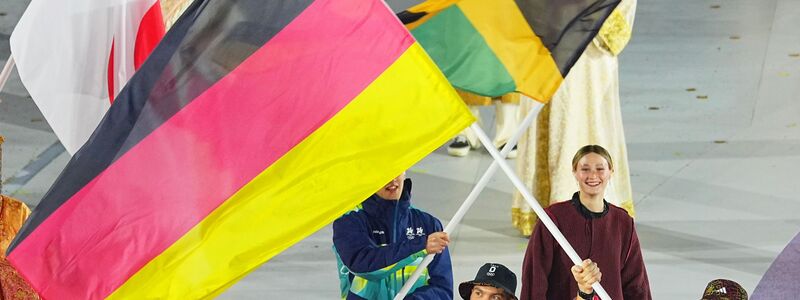 Tobias Wendl (l) und Tobias Arlt tragen die deutsche Fahne.  - Foto: Michael Kappeler/dpa