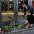 Dänemarks Ministerpräsidentin Mette Frederiksen legt Blumen am Eingang des Einkaufszentrums Field's nieder. - Foto: Sergei Grits/AP/dpa