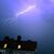 Ein Blitz erhellt den abendlichen Himmel über einem Kirchturm in Kaufbeuren. - Foto: Karl-Josef Hildenbrand/dpa
