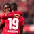 Die Leverkusener Jeremie Frimpong (l) und Moussa Diaby bejubeln den Sieg gegen den FC Schalke 04. - Foto: Marius Becker/dpa