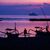 Männer befestigen vor Sonnenaufgang am Tag vor Beginn des G20-Gipfels am Strand von Nusa Dua Boote. Im Hintergrund ist ein Schiff der indonesischen Marine zu sehen. - Foto: Christoph Soeder/dpa