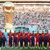 Spieler des Iran stehen beim Abspielen der Nationalhymne vor dem übergroßen Weltpokal im Stadion in Katar. - Foto: Han Yan/XinHua/dpa
