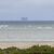 Der Autofrachter «Fremantle Highway» ist vom Strand der niederländischen Insel Schiermonnikoog aus am Horizont zu sehen. - Foto: Anton Kappers/vifogra/dpa