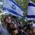Menschen nehmen in London an einer Mahnwache der Jüdischen Gemeinde teil. - Foto: Kin Cheung/AP/dpa