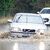 Autos fahren durch das Hochwasser in der Nähe von Whitley Bay an der Nordostküste Englands. Das aufziehende Sturmtief bereits für heftigen Regen gesorgt. - Foto: Owen Humphreys/PA Wire/dpa