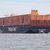 Das Containerschiff «Berlin Express» der Reederei Hapag-Lloyd auf der Elbe: Die Reederei fährt ein schächeres Ergebnis ein. - Foto: Bodo Marks/dpa